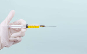 hand with syringe full of ozempic